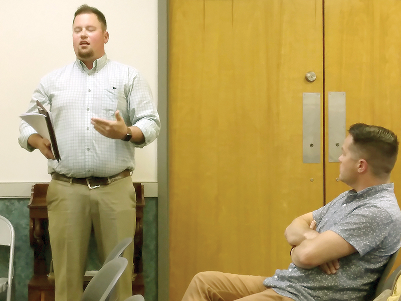Insurance agents Brett Cantrell, left, and Chris Wang, seated, were among those who spoke about local housing issues during a recent meeting of the Ellijay Downtown Development Authority. 