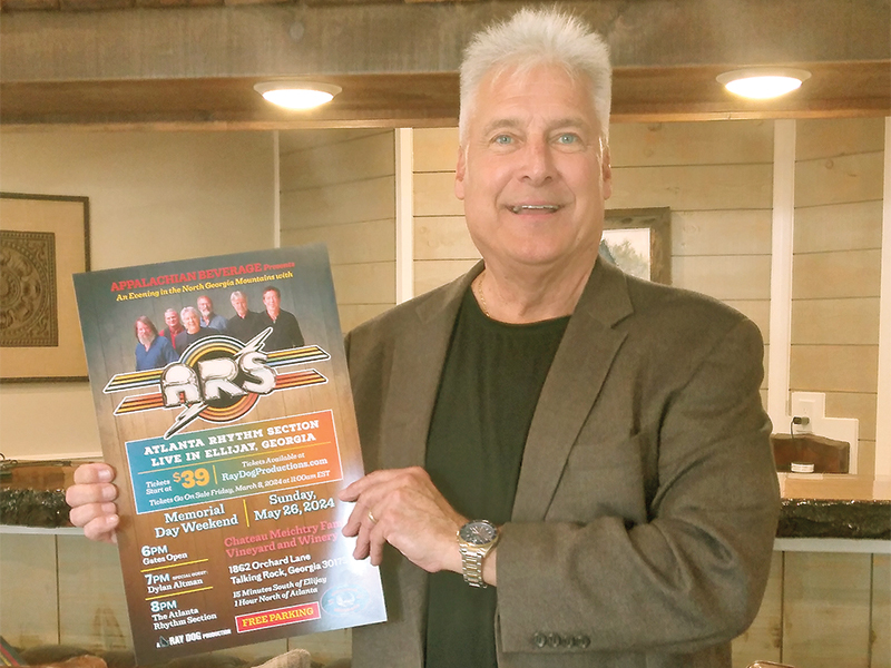 Promoter Ray Green holds a poster for the Atlanta Rhythm Section concert, which will take place Memorial Day weekend. 