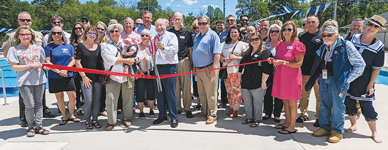 Commission Chairman Charlie Paris cuts the ribbon on the new county swimming pool at a Gilmer Chamber ceremony held last week. (Gilmer Chamber photo)