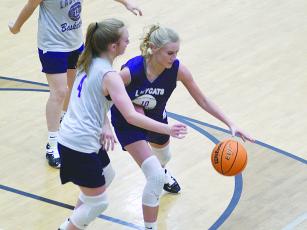 Gilmer High’s Lark Reece (purple) is one of two seniors returning on this season’s Lady Cat basketball team.