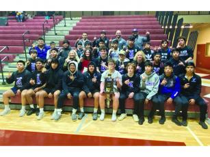Gilmer High School wrestlers, coaches and managers gather after the Bobcats’ area duals championship last Saturday.