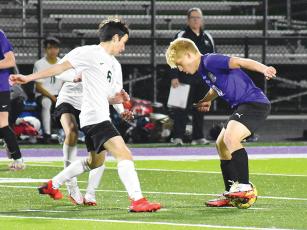 Bobcat senior midfielder Julien Withrow (10) dribbles to draw in Dragon defenders to create open space for teammates.