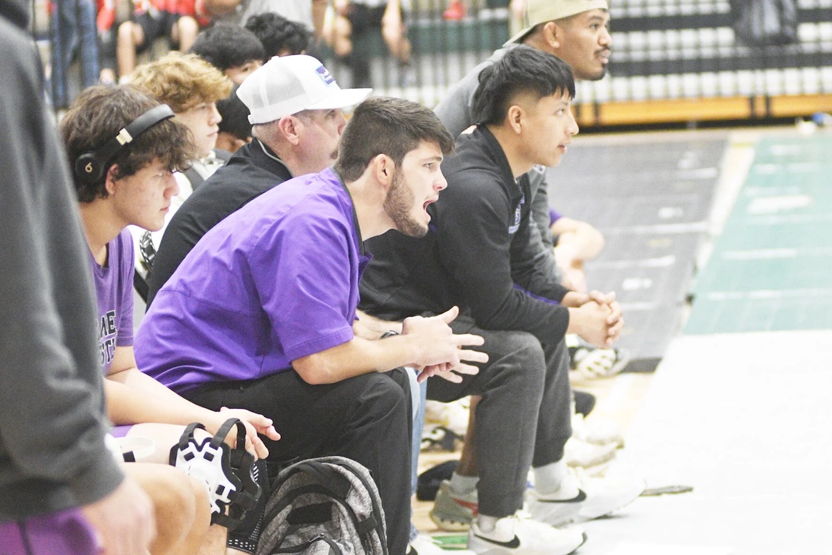 Caleb Waddell (in purple) gives instructions during his first season as Gilmer’s head coach last year.