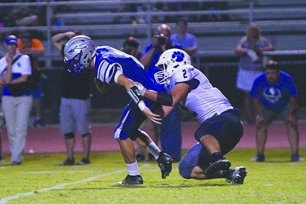 Gilmer’s Kyle Allison sacks Warrior quarterback Sean Gray.