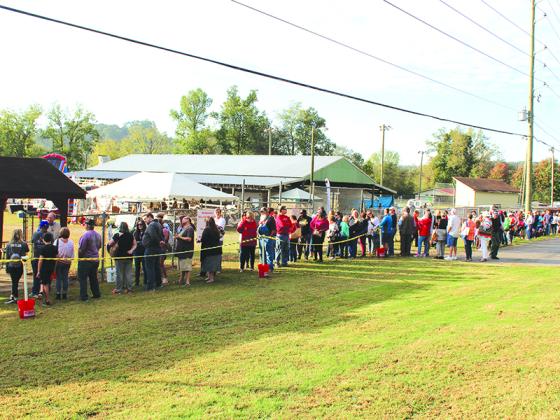 Well over 100 people line up Saturday morning at just one gate to get into the Apple Festival. Times for the final weekend are 9 a.m.-6 p.m. on Saturday, and 9 a.m.-5 p.m. on Sunday. Admission is $5 for adults, and free for children 10 and under.