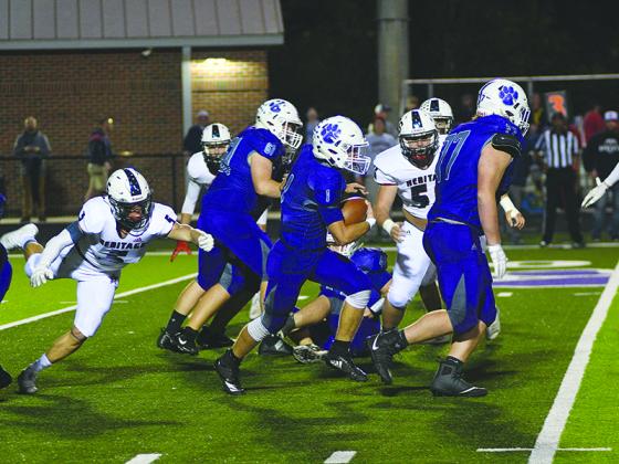Gilmer sophomore running back Kobe Stonecipher (1) makes a defender miss as he gets blocks from senior linemen Luke Morgan (61) and Jace McClure (77). Stonecipher rushed for 169 yards and a touchdown on 23 attempts versus Heritage last Friday.