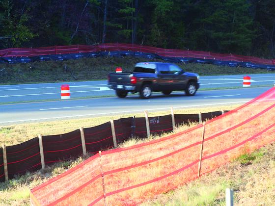 Silt and barrier fencing have been installed along the sides of Highway 515 as part of construction that will eventually connect Highway 382 with 515. 