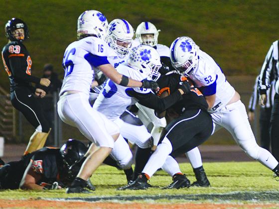 From left, Gilmer defenders Braden Jenkins (16), Ashton White, Cameron Weaver (45) and Will Bradburn (52) stop LaFayette’s Jamario Clements. 