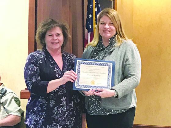 Gilmer County School’s chief financial officer Trina Penland (left) is presented with the Certificate of Achievement for Excellent Financial Reporting by Georgia Department of Audits manager Mary Dilbeck.