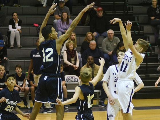 Seventh-grade Bobcat Boston Teague (11) fires a jumpshot.