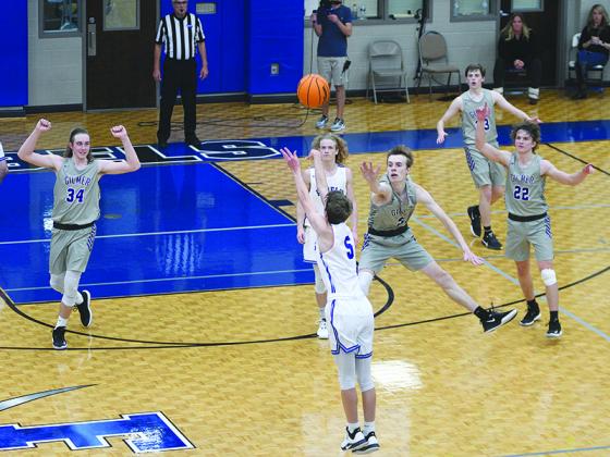 Fannin’s Kaeden Twiggs fires a shot at the buzzer as Gilmer’s Brady Sanford defends and teammates Cade Carter (34) and Braden Jenkins (22) prepare to celebrate the miss.