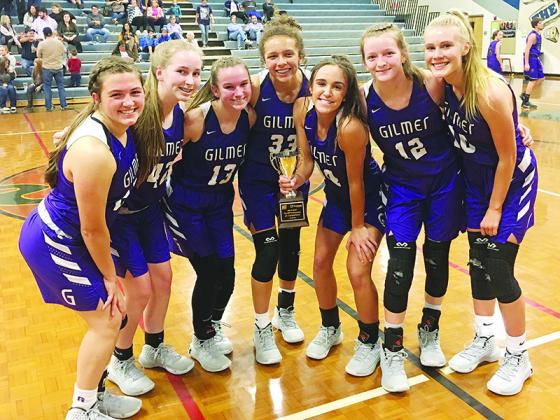 Gilmer High junior varsity Lady Cats gather around their first-place trophy from the ETC/Piedmont Mountainside Tip-Off Tournament.