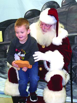 Samuel Doss is happy about getting a toy wooden car after his visit with Santa.