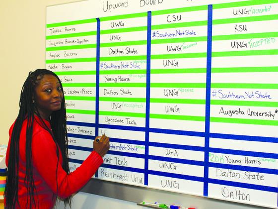 Latrice Richardson, coordinator of the federally-funded Upward Bound program at Gilmer High School, keeps track of students’ college campus visits on one of two boards. 