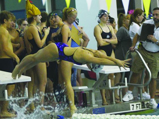 Gilmer High sophomore Payton Woodring dives into the pool during a recent meet.