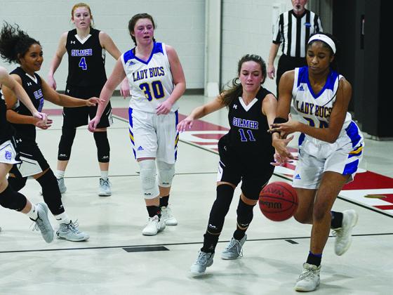 Lady Cat Beth Burnette (11) pokes the ball loose in the last round of the Carpet Capital Christmas Classic.