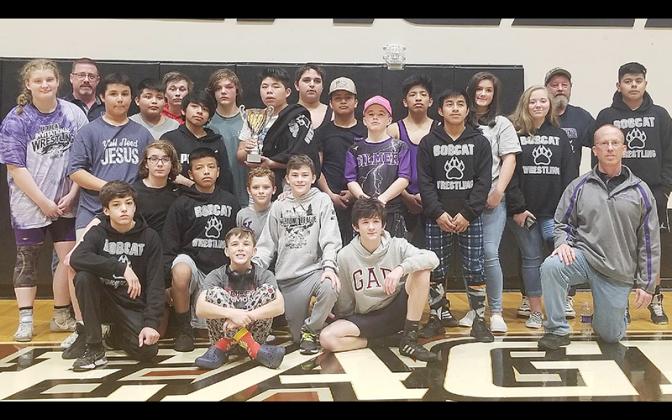 The Clear Creek Bobcats gather around their third-place trophy from the Georgia Middle School State Duals last Saturday in Hall County. 