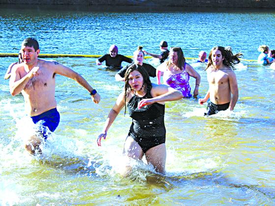 Participants hustle to get out of the 52-degree lake.