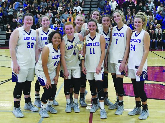 The Gilmer High Lady Cats gather around their runner-up trophy after Monday night’s loss to Northwest Whitfield in the Region 6-4A championship. Front row, from left are Jasmine Staley, Hope Colwell and Beth Burnette. Back row, are Jalynn Ledford, Bailey Teague, Lark Reece, Emma Deyton, Anne Elise Williams, Elly Callihan and Emma Callihan.