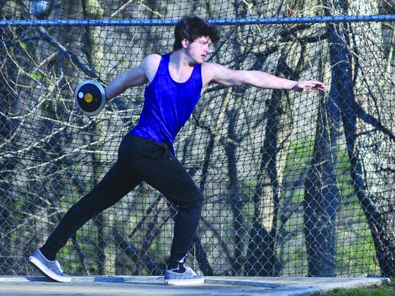 Bobcat Logan Ellis winds up to throw the discus.