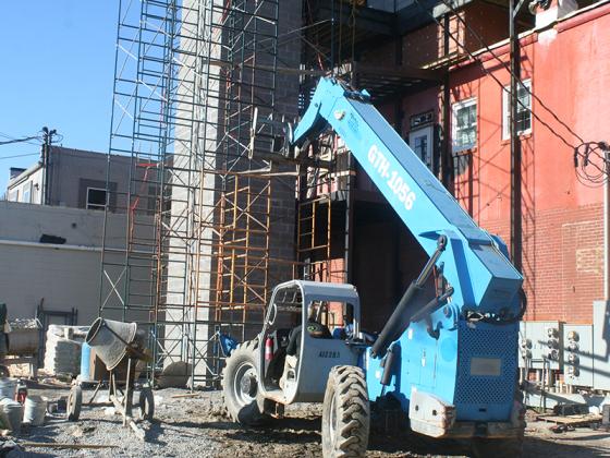 A telehandler forklift is used to lift supplies to the upper level of an elevator shaft currently under construction just off Church Street in downtown Ellijay.