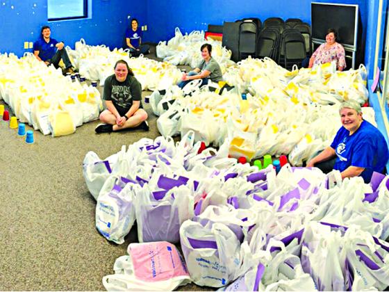 Nine volunteers spent 18 hours assembling 700 learning kits.