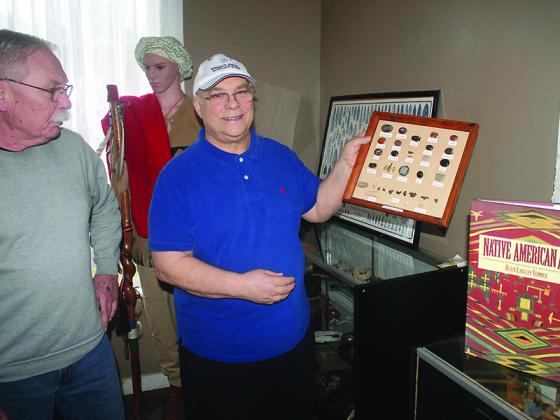 Dan Lehr, left, and Wayne Hooper, both of the Gilmer Historical Society, are shown arranging an exhibit at the Tabor House Museum last month. The downtown Ellijay museum had planned to reopen April 2, but will now remain closed until further notice.
