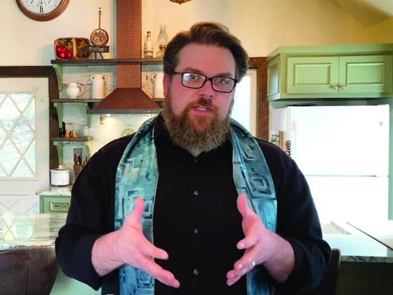 Pastor Adam Bradley delivers a sermon from home to members of Cherry Log Christian Church.