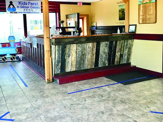 The interview area at the Gilmer Community Food Pantry has been updated with blue tape and Xs in practice with social distancing measures being taken there.