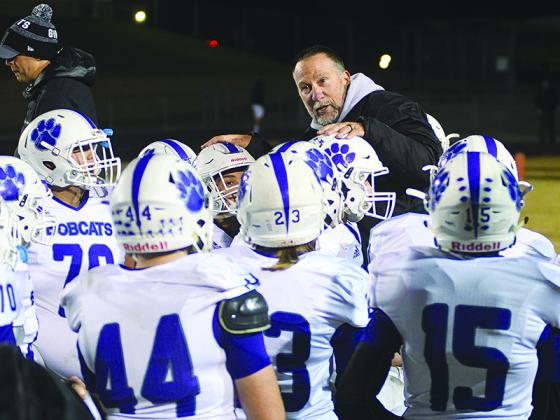 Gilmer High head football coach Kevin Saunders addresses Bobcat players after their final game of last season.