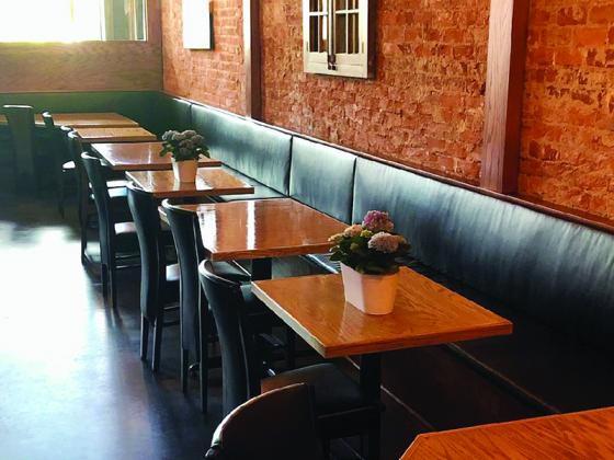 Potted flowers sit on every other table in the dining area of Emily’s Bar and Restaurant so customers can be seated six feet apart.