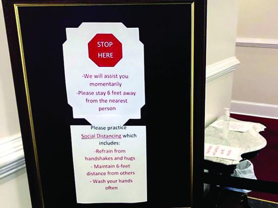 Signs posted at Logan Funeral Home, notify those attending funerals or visitations at either establishment to limit physical contact and maintain distancing of at least six feet.