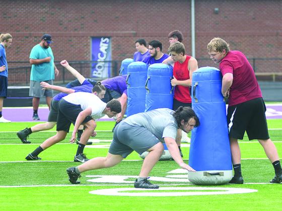 Gilmer High offensive linemen work on their blocking technique during a conditioning session last Wednesday.