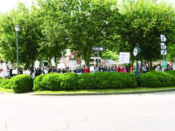 A crowd of people hold up signs during a rally on the square in downtown Ellijay on June 4. Organizers said  the wanted to give people a place to voice their frustrations and concerns over racism.