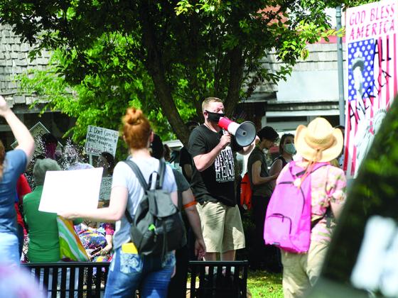 A crowd of people hold up signs during a rally on the square in downtown Ellijay on June 4. Organizers said  the wanted to give people a place to voice their frustrations and concerns over racism.
