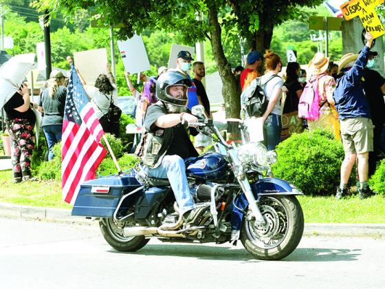A crowd of people hold up signs during a rally on the square in downtown Ellijay on June 4. Organizers said  the wanted to give people a place to voice their frustrations and concerns over racism.