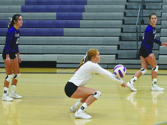 Gilmer libero Hope Colwell digs a serve last Friday versus Murray County as fellow seniors Beth Burnette and Emma Deyton get in position.