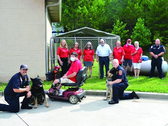 From left, in back: Rebecca Harrell (FOGAS treasurer), Marla Swanberg (FOGAS president), Sylvia Harris (FOGAS secretary), Paris, Susan Lebert (FOGAS volunteer), Jack Peaden (FOGAS vice president), Glen Peaden (FOGAS volunteer) and Deputy Fire Chief Mark Chastain. In front, from left: Lt. Mikey Bramlett, search dog in training Duke, Ernie Taylor (FOGAS volunteer), search dog in training Axel and Battalion Chief Mike Dempsey. 