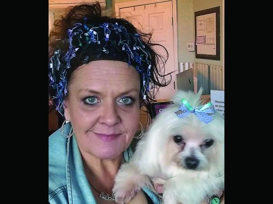 Above, dog groomer Erin O’Neill is pictured with one of her canine clients, Oliver. 