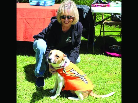 Volunteer Donna Lehr spends time with Homeward Bound resident Dixie at the Cherry Log Community Church Garden Festival.
