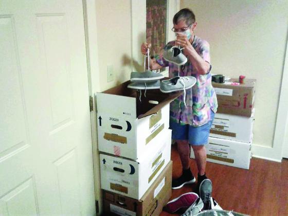 Diana Barbato, coordinator of the Shoes For Orphan Souls collection effort at Ellijay Hope Lutheran Church, boxes some of the shoes that have been donated since the drive began in July.