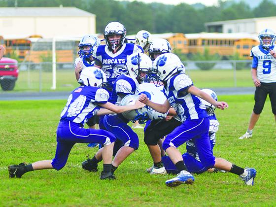 The Clear Creek seventh-grade Bobcats rally to make a gang tackle versus Fannin County last Thursday.