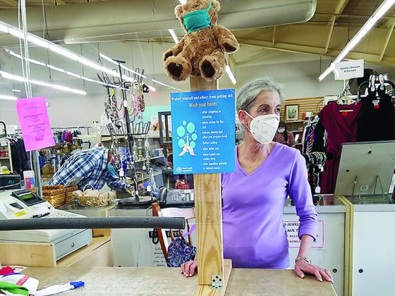 Faith, Hope and Charity Recycle Store cashier Debra Wise waits for her next customer at the store’s sneeze-guarded counter.