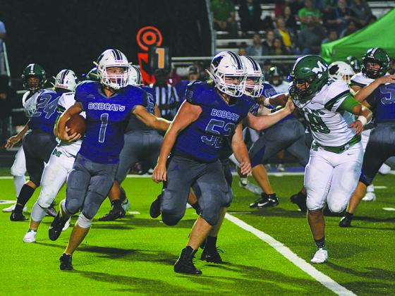Gilmer’s Kobe Stonecipher (1) gets behind the blocks of lineman Will Bradburn (52) and wingback Gray McClure during last Friday’s win versus Murray County. Stonecipher rushed 12 times for 70 yards and two touchdowns and returned a punt 68 yards to the 1-yard line to set up another touchdown.