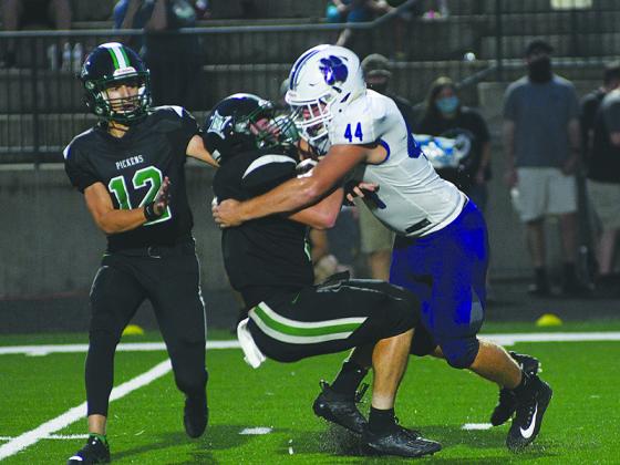 Bobcat senior Cameron Weaver stops Pickens’ Jarod Whitmore for a 4-yard loss during last Friday’s game in Jasper.
