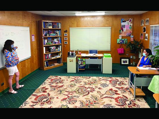 Teacher Dita Paukert, left, and student Angela Casas are socially distanced during a recent one-on-one study session at the Gilmer Learning Center.