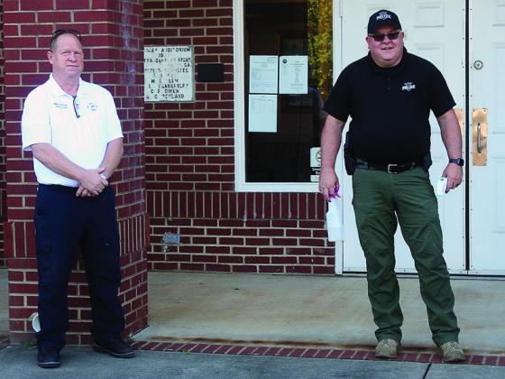 Before you enter ... Ellijay Deputy Fire Chief Mike Dempsey, left, and Ellijay Police Capt. Ray Grace are pictured outside City Hall checking temperatures and dispensing hand sanitizer for attendees at this month’s Ellijay City Council meeting.