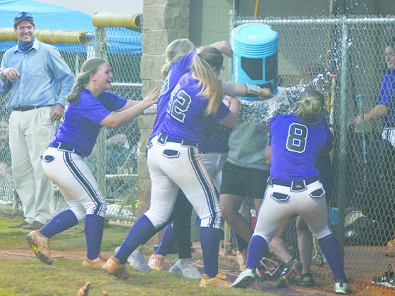 Gilmer High coaches Amanda Mullis and Ashley Waters and players celebrate the Cats’ region championship following their 3-1 win over Dawson County last Tuesday.