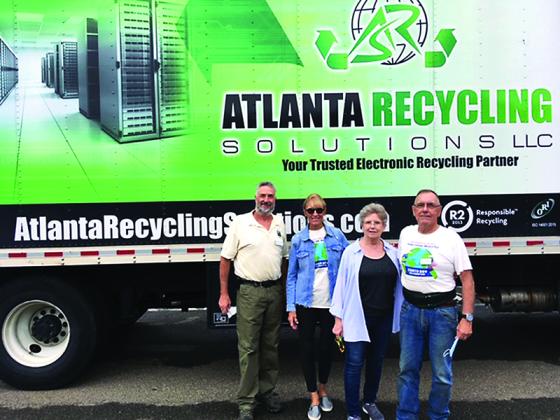 Keep Gilmer Beautiful members Jay Zipperman, Karen Vitelli, MyKey Cook and Jim Harris are pictured with the box truck that was filled with discarded electronic items during the group’s first e-recycling event. 