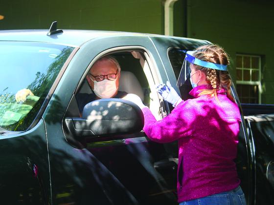 Racquel Watkins, Gilmer Health Department Registered Nurse, takes care of a patient during the health department’s drive-thru flu shot clinic held last month at the ETC Pavilion.
